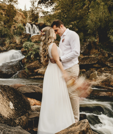 Wedding couple by waterfall